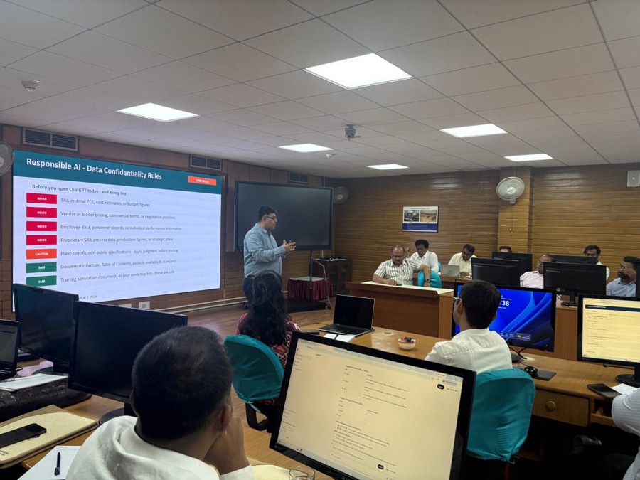 An EigenSpark session in progress: a trainer presenting responsible-AI data rules to a room of analysts at workstations.